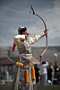 Markswoman Photo: The archery portion of the Naadam Festival held in July each year.  A female archer in elegant Mongolian dress aims to topple a small wall of marked blocks from over half a football field away.  The skill demonstrated by the archers in the competition is absolutely amazing as they more often than not hit the center portion of the marked blocks.  What's even more amazing, to me at least, is that they arc the arrows at the target as you can see from the position of this archer's bow, yet still manage to hit the target consistently.