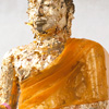 Golden Buddha Photo: A statue of Buddha covered by pilgrims in small sheets of gold leaf.