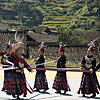 Rooftops & Dancing (Miao IV) Photo: Miao ethnic minority women present a dance performance for a local festival.