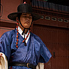 Gatekeepers Photo: A guard carrying the royal flag stands aside the main entrance to Gyeongbokgung Palace.