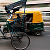 Roti-Powered Photo: A cycle rickshaw driver offers a quick glance in busy downtown traffic.