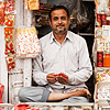 Indian Style Photo: A store owner sits cross-legged in the cramped quarters of his jewelry store.