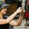 Shutterbugs Photo: A Chinese woman strikes an atypical stance to capture a low subject.
