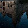 Slick Sidewalk Photo: Former King's castle, Het Steen (The Stone), reflected in a puddle of rainwater.