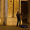 Street Symphony Photo: A street violinist performs outside the entrance of the Cathedral of Our Lady.