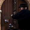 Movable Type Photo: The driver of a horse and buggy gestures toward the door plaque of the Plantin-Moretus museum.