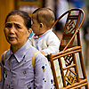 Li'l Luggage Photo: A grandmother carries a baby in a traditional wooden baby carrier.