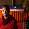 Shawl & Wall Photo: A Buddhist monk stands in a small monastery's courtyard inside the temple complex of Dhankar.