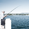 Flush Fisherman Photo: A Swiss man fishes from a boat dock into Lake Geneva.