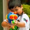 Songkran Shooting Photo: A young Thai boy takes aim at a defenseless, unarmed photographer during Songkran.