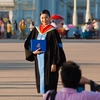 Advanced Degree Photo: A newly minted university graduate poses for a photo in front of the Ananta Samakhom Throne Hall in Bangkok.